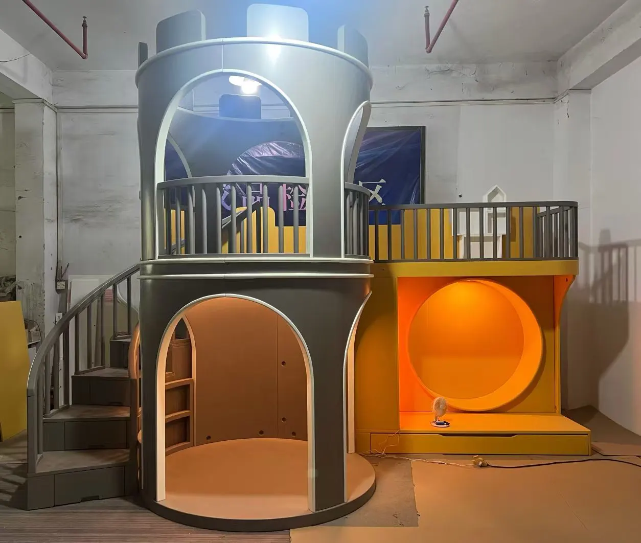 Bespoke castle-shaped children's bedroom with a tower and slide