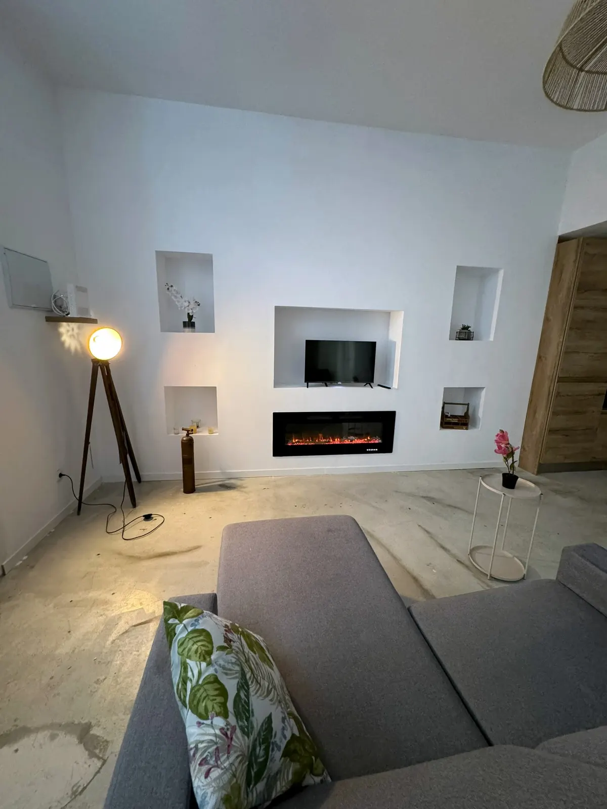 Living room with niches and a fireplace in a former commercial unit converted into a home